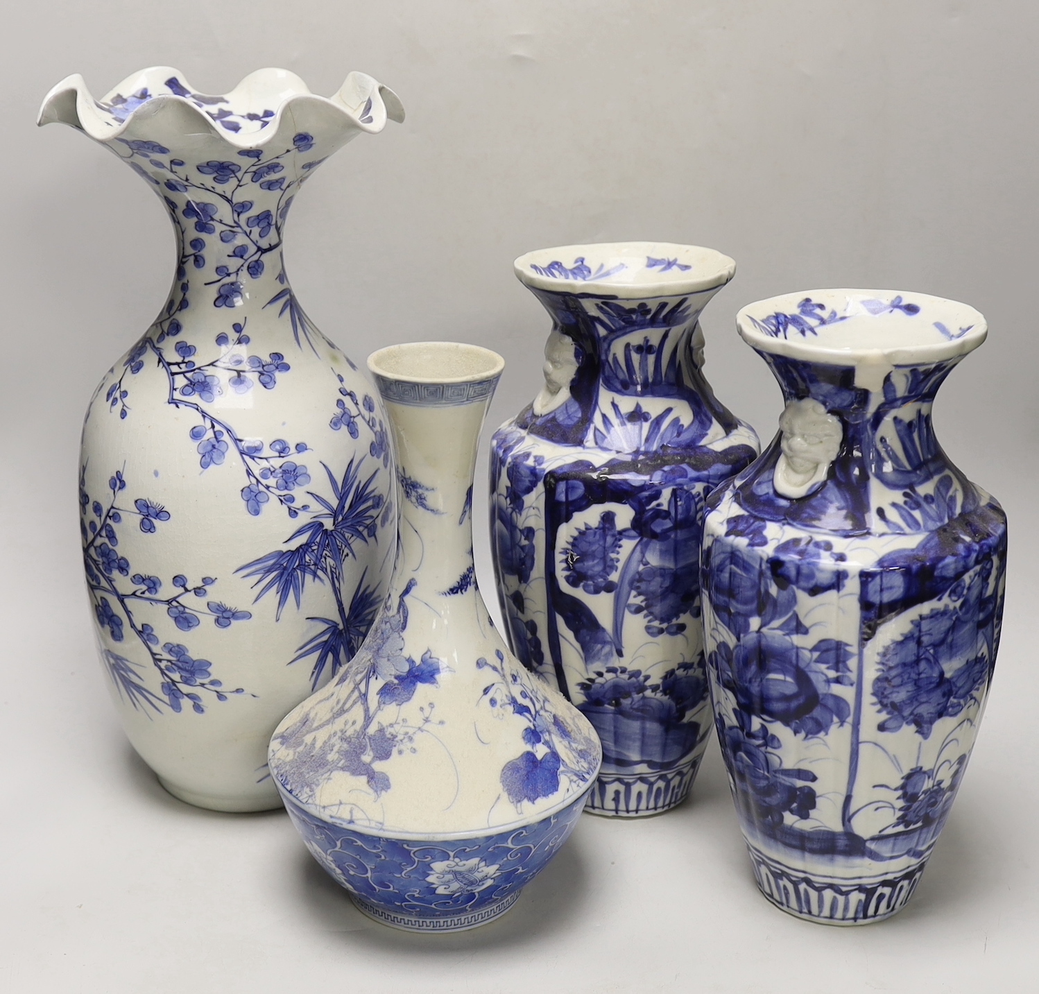 A pair of Japanese blue and white birds and flowers pattern vases and two other vases, tallest 39cm high